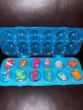 Hatchimals Blue Egg Carton Case with 12 Colorful Mini Animal Figures.